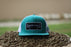 russell-feed-patch-trucker-hat-teal-white